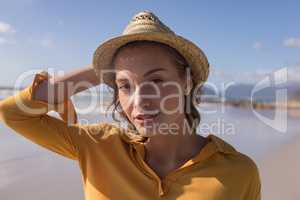 Woman in hat standing on the beach