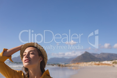 Woman in hat standing on the beach