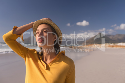 Woman in hat standing on the beach