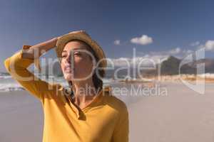 Woman in hat standing on the beach