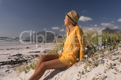 Woman in hat relaxing on the beach