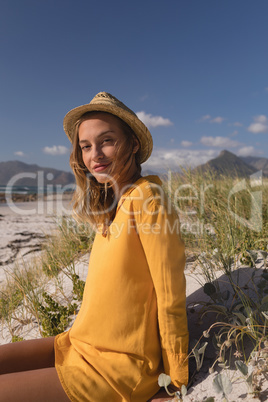 Woman in hat relaxing on the beach