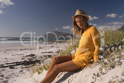 Woman in hat relaxing on the beach