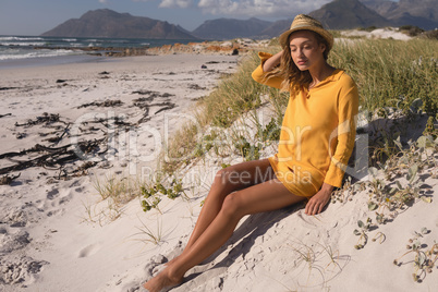 Woman in hat relaxing on the beach