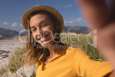 Woman wearing hat relaxing on the beach