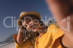 Woman wearing hat relaxing on the beach