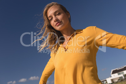 Woman standing with arms outstretched on the beach