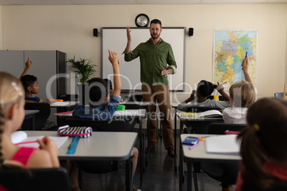 School teacher teaching in a classroom of elementary school