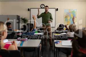 School teacher teaching in a classroom of elementary school