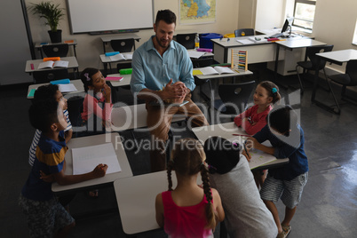 Male teacher teaching in classroom of elementary school