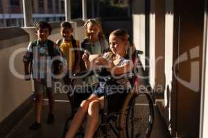 Disable schoolgirl using smartphone in hallway