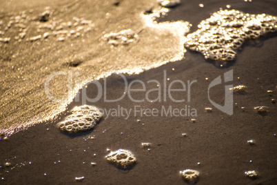 Foam bubbles of the surf on sand Foam bubbles of the surf on sand