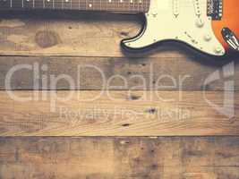 Old vintage guitar on rustic wood