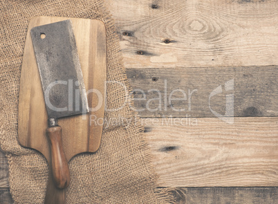 Old used meat cleaver on wood