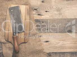 Old used meat cleaver on wood