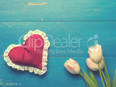 Pink tulips with a red heart shape
