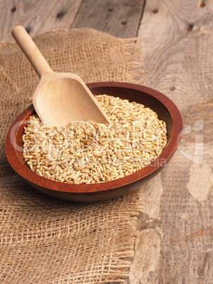 Peeled oats in a wooden bowl