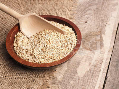 Peeled oats in a wooden bowl