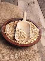Peeled oats in a wooden bowl