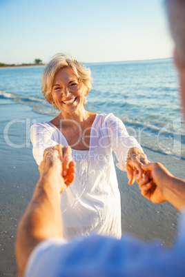 Happy Senior Couple Dancing Holding Hands on Sunset Beach