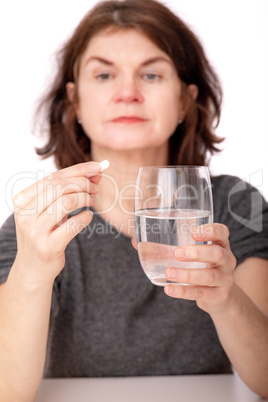 Woman with tablet and water glass