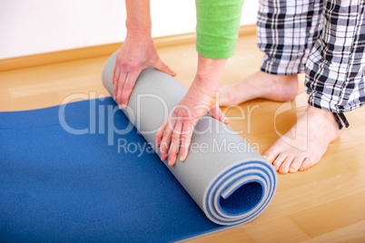 Woman with gymnastics mat