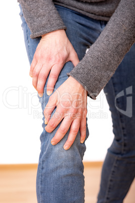 Person holds the aching knee