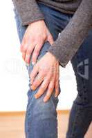 Person holds the aching knee