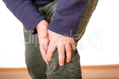 Person holds the aching knee