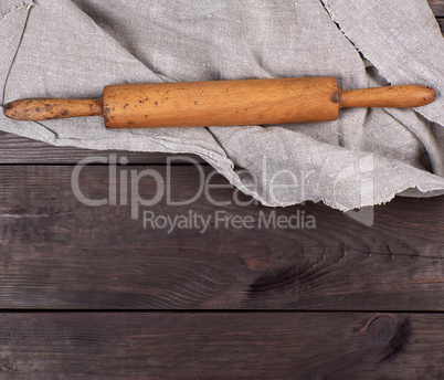wooden rolling pin and gray textile towel