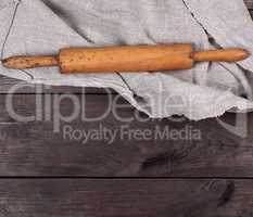 wooden rolling pin and gray textile towel