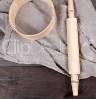 wooden rolling pin and round wooden sieve