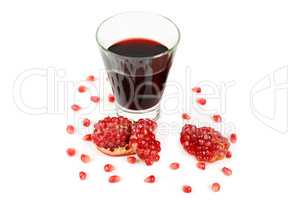 Glass of pomegranate juice with fruit isolated on white.