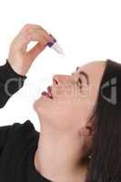 Woman putting eye drops in her dry eyes