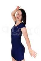 Woman standing in a blue tight dress hands up