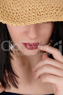 Mysterious woman with big straw hat in close up