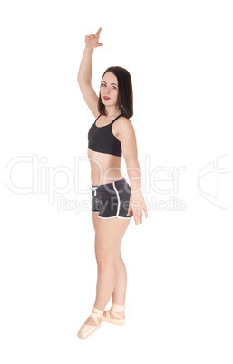 Dancing young woman standing in profile and shorts