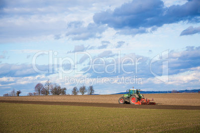 tractor plowing ground in the spring