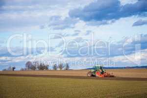 tractor plowing ground in the spring