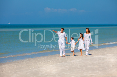 Mother, Father and Children Family Walking on Beach