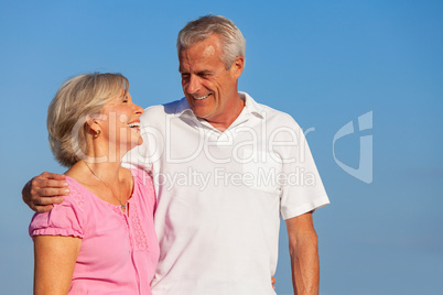 Happy Senior Couple Walking Embracing in Blue Sky