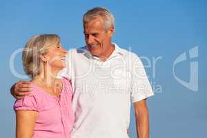 Happy Senior Couple Walking Embracing in Blue Sky