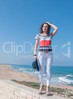 Girl in white jeans by the sea