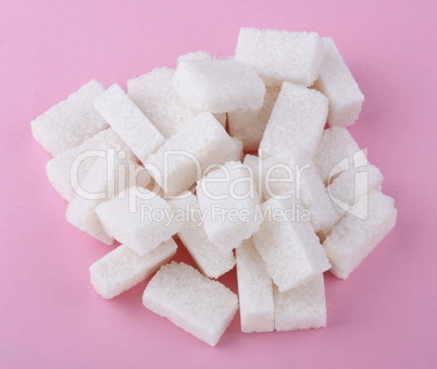 heap of sugar on pink background