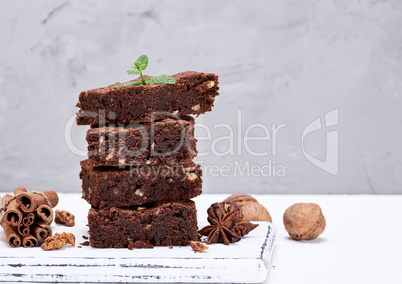 baked square pieces of chocolate brownies with walnuts