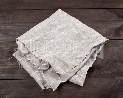 folded gray towel on brown wooden background