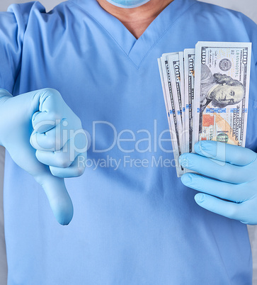 doctor in blue uniform and latex gloves keeps one hand a lot of