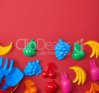 plastic childrens toys in the form of fruit and a bucket