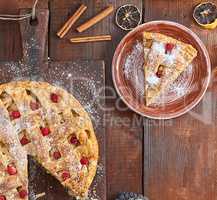 apple pie on a rectangular old brown cutting board sprinkled wit