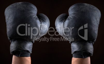 old boxing gloves dressed on man's hands